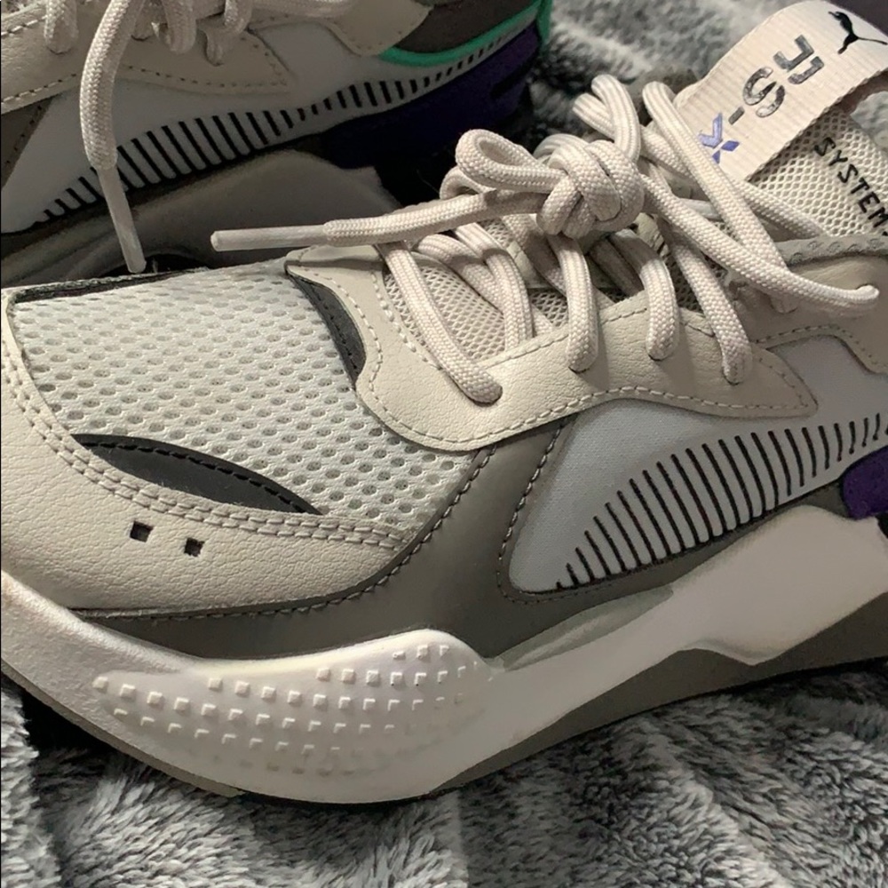 Grey , purple and green puma sneakers .